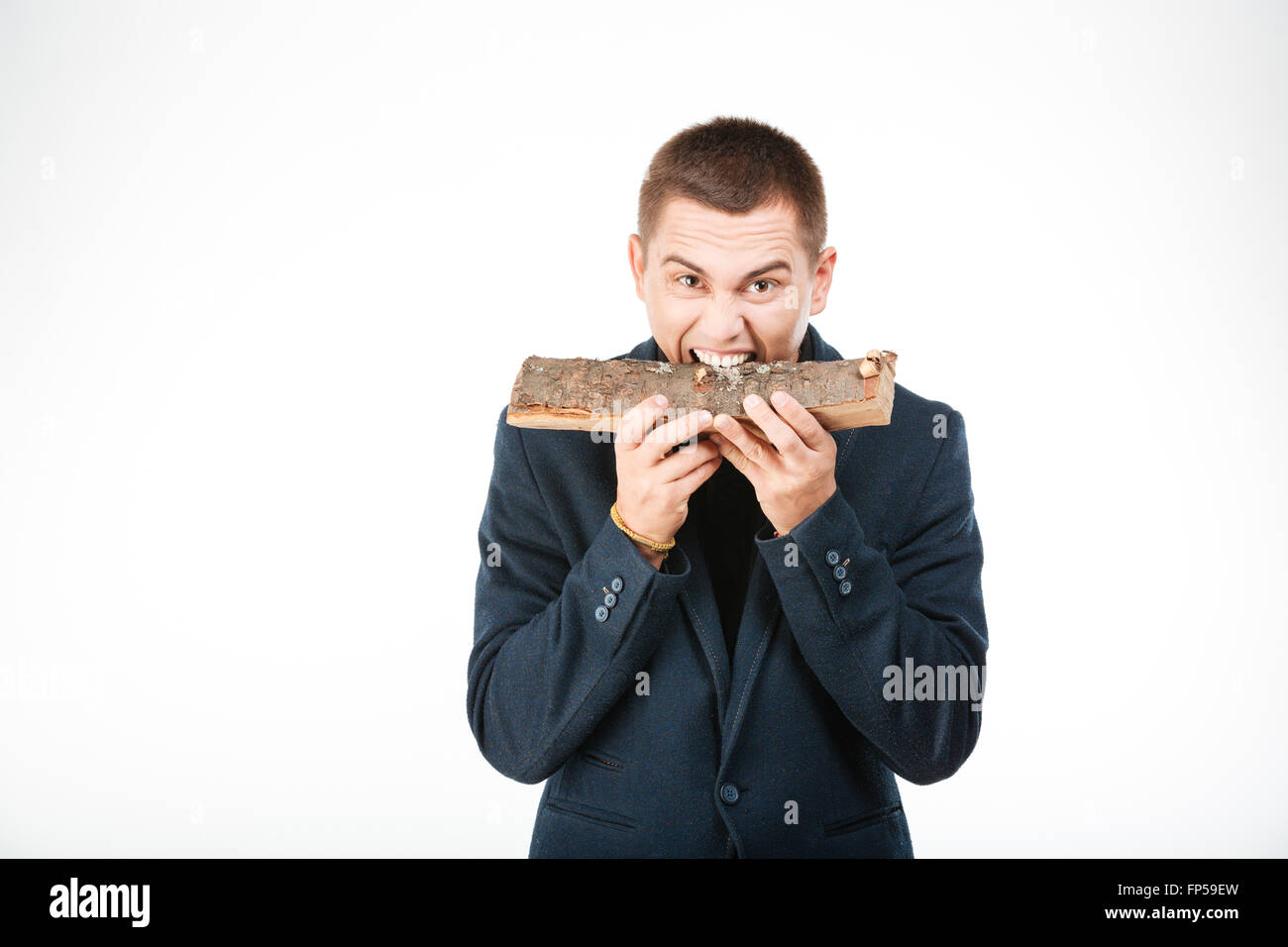 Businessman biting wooden timber isolated on a white background Stock Photo