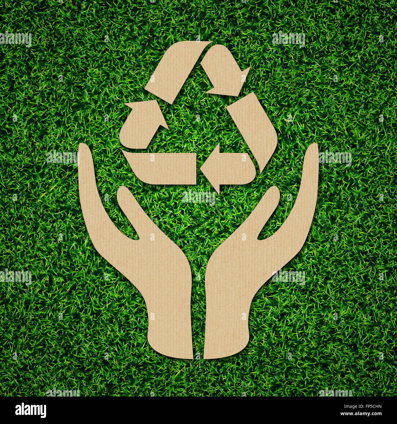 Recycle, reduce, reuse icon symbol concept on green grass. Stock Photo