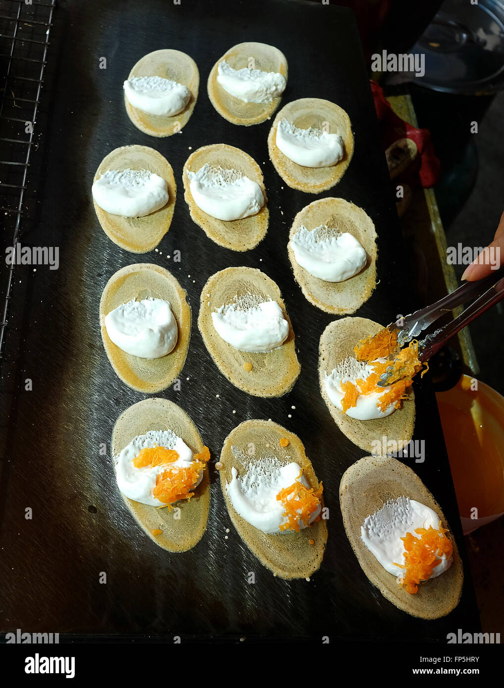 Khanom Beaung Thai or a kind of filled pancake Thai food or Thai Style Crisp Tart on tray, Thailand - (Selective focus) Stock Photo