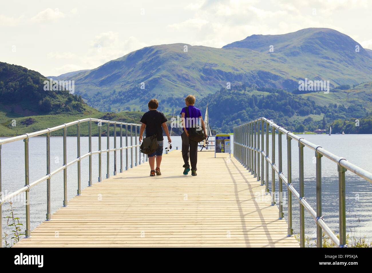 Lake District National Park. Boys going fishing. Aira Force Jetty lake Ullswater. Lake District National Park, Cumbria, England. Stock Photo