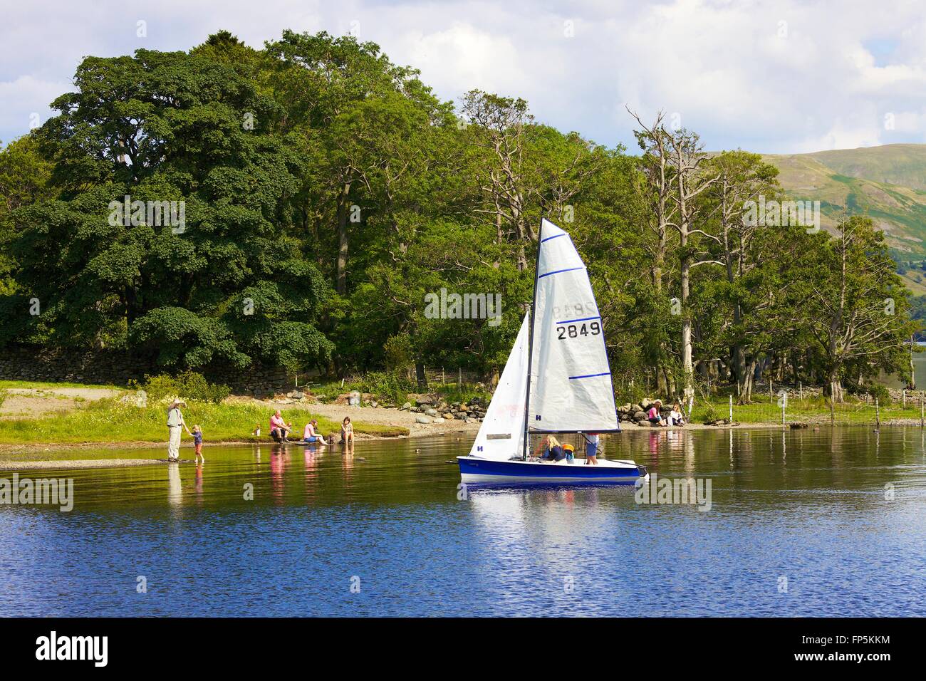 Lake District National Park. Family dinghy sailing on lake. Aira Force Bay, Ullswater, Penrith, Lake District, Cumbria, England. Stock Photo