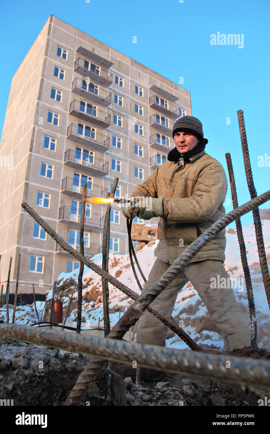 The welding worker in the construction site making reinforcement metal ...