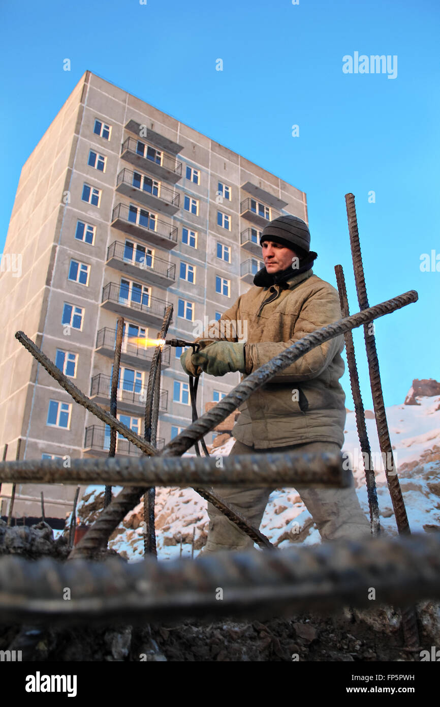 The welding worker in the construction site making reinforcement metal ...