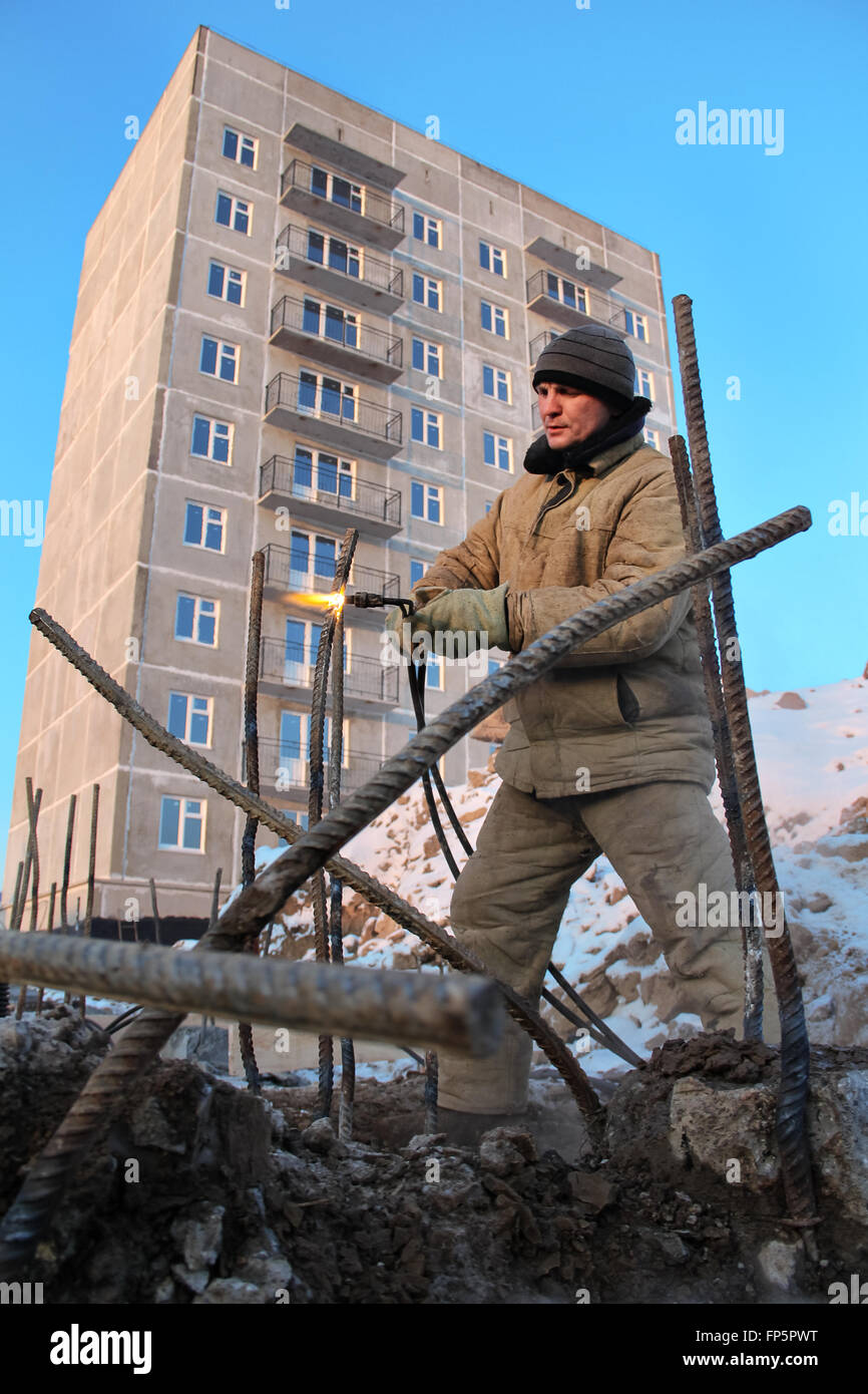 The welding worker in the construction site making reinforcement metal ...
