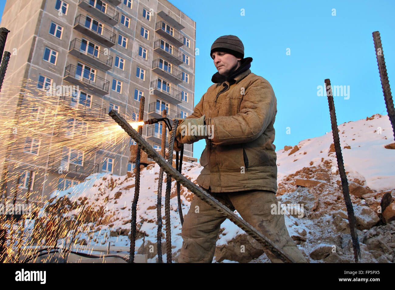 The welding worker in the construction site making reinforcement metal ...