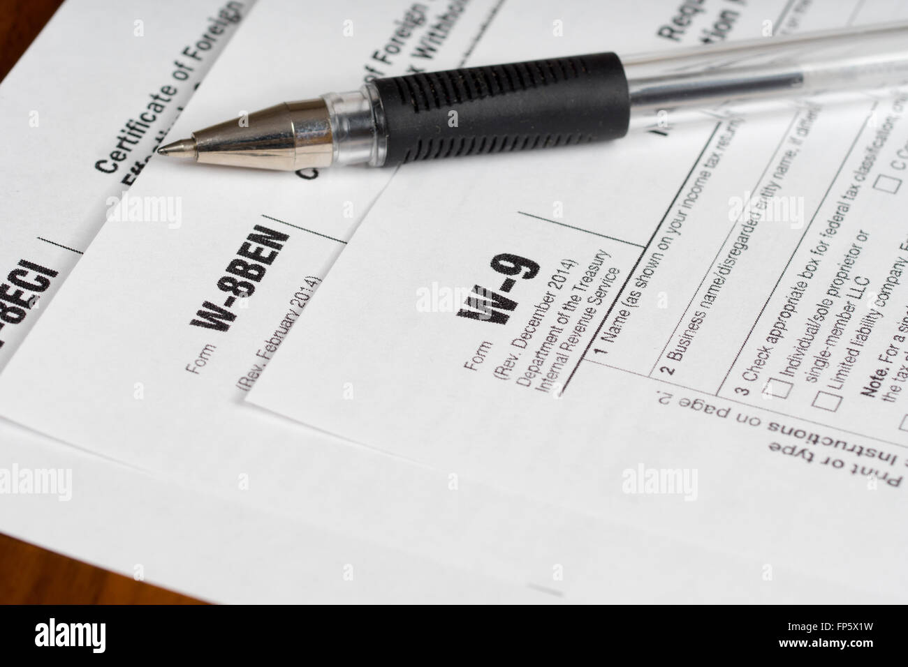 tax reporting forms with opened black pen Stock Photo