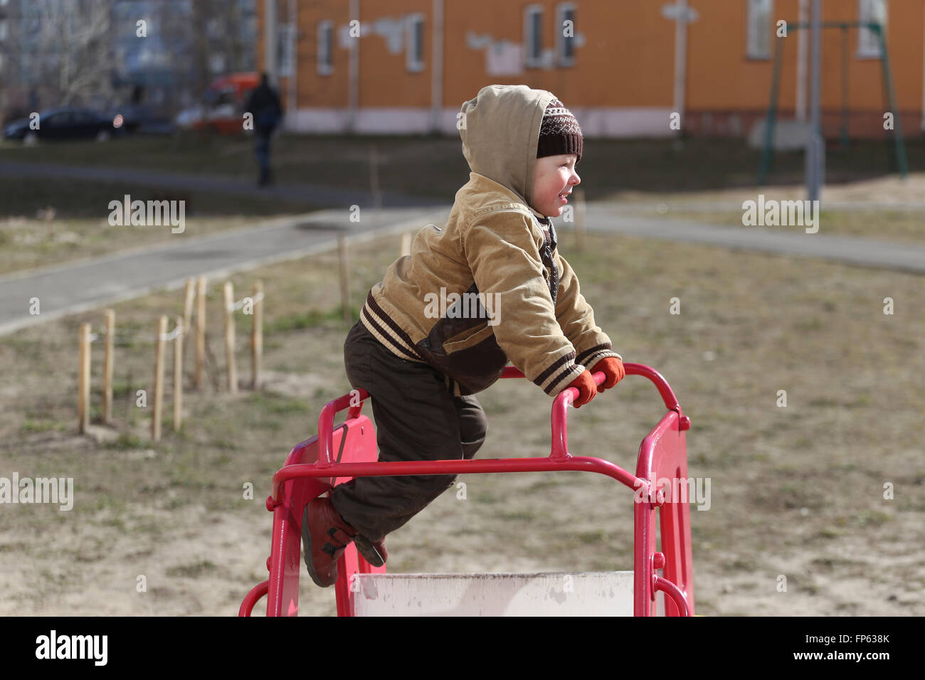 children play on the playground. early spring Stock Photo