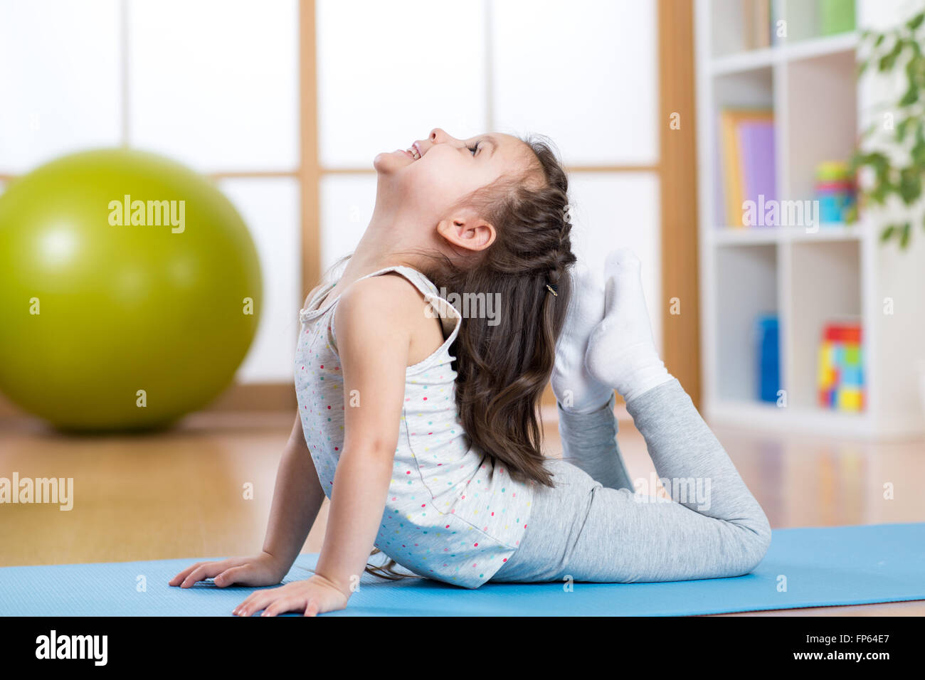 Child girl doing gymnastics Stock Photo