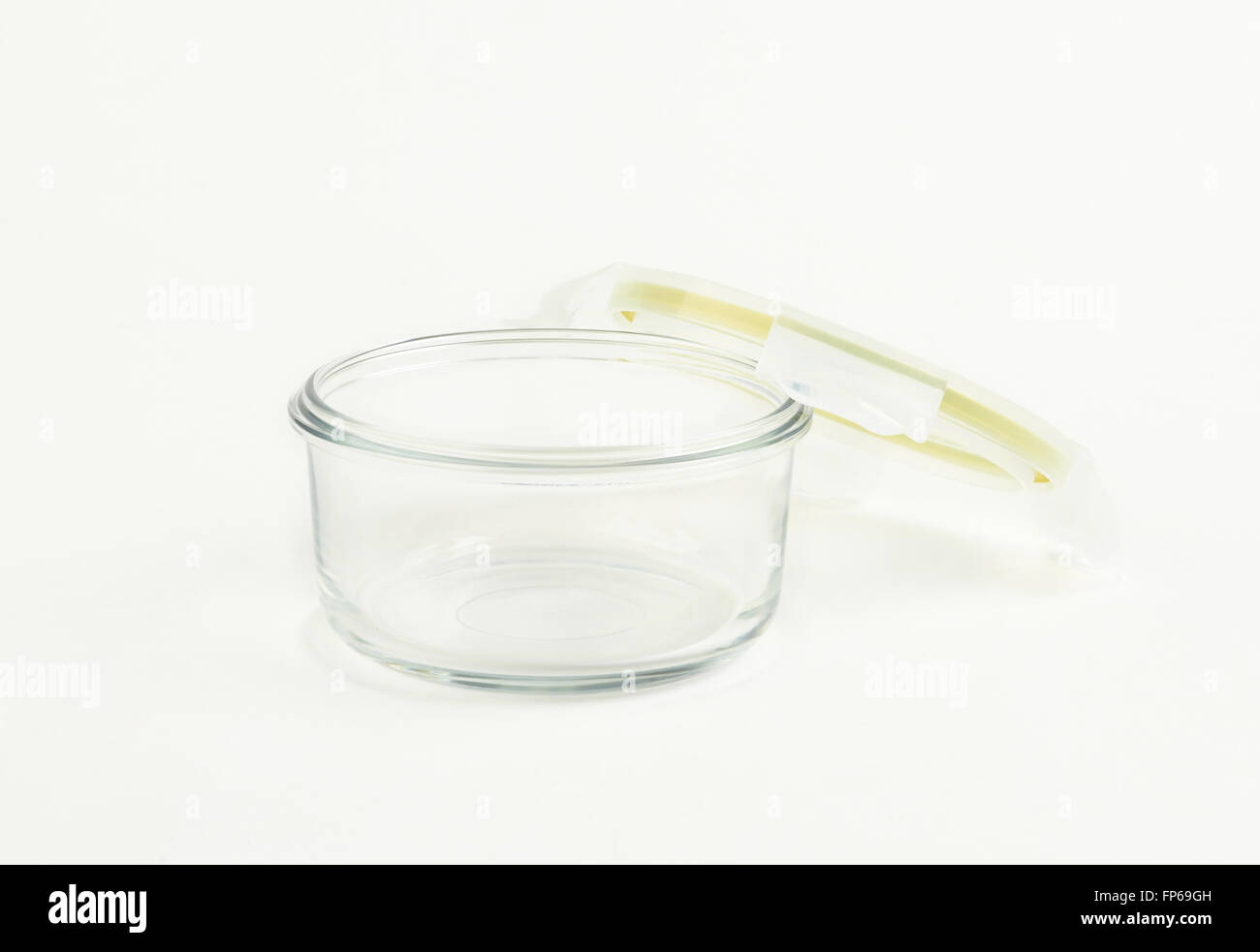 Glass food container with plastic lid on white background Stock Photo
