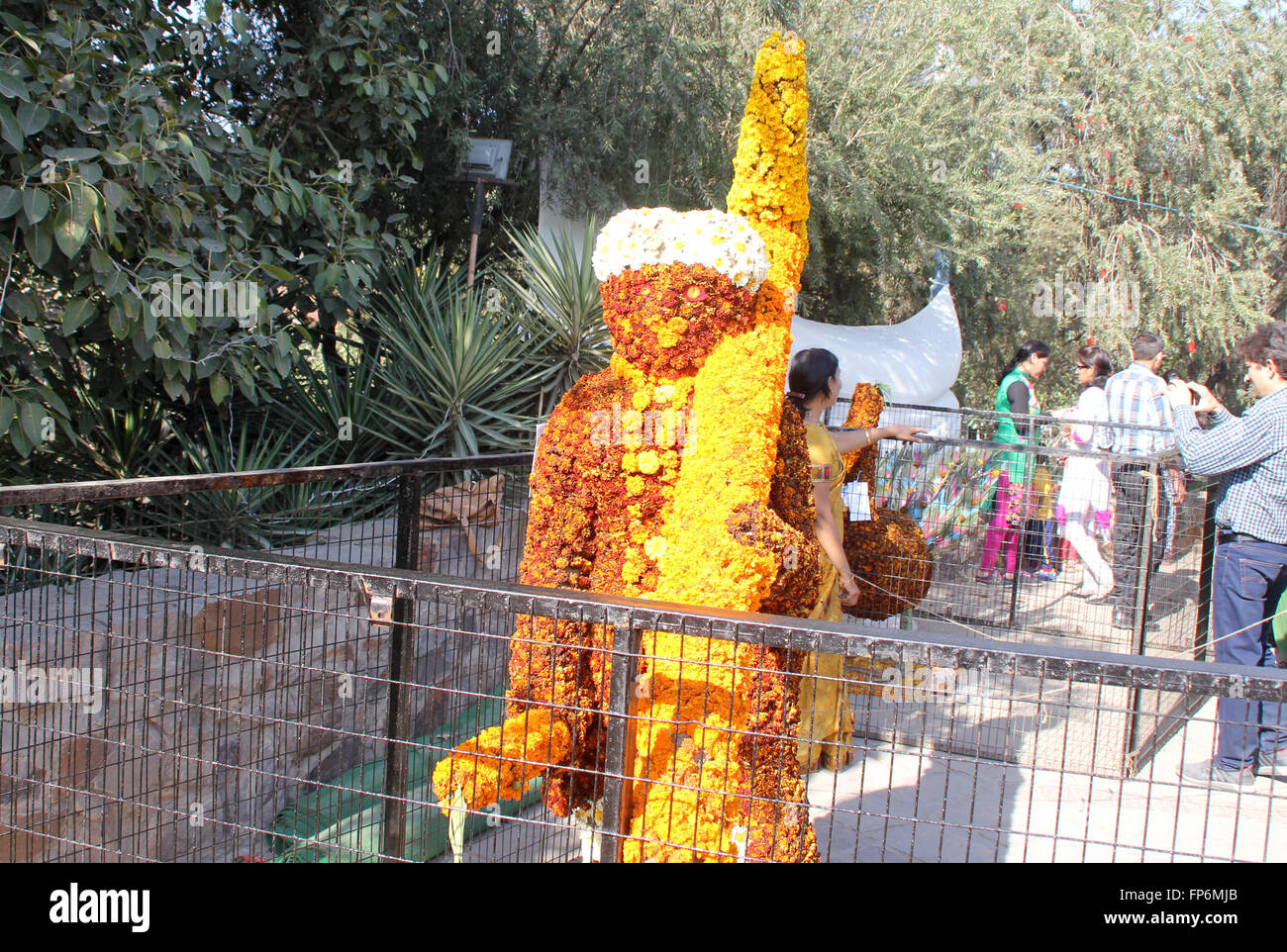 Floral man, displayed at Garden Festival, made from flower heads of Marigold, carrying a floral rod on shoulder Stock Photo