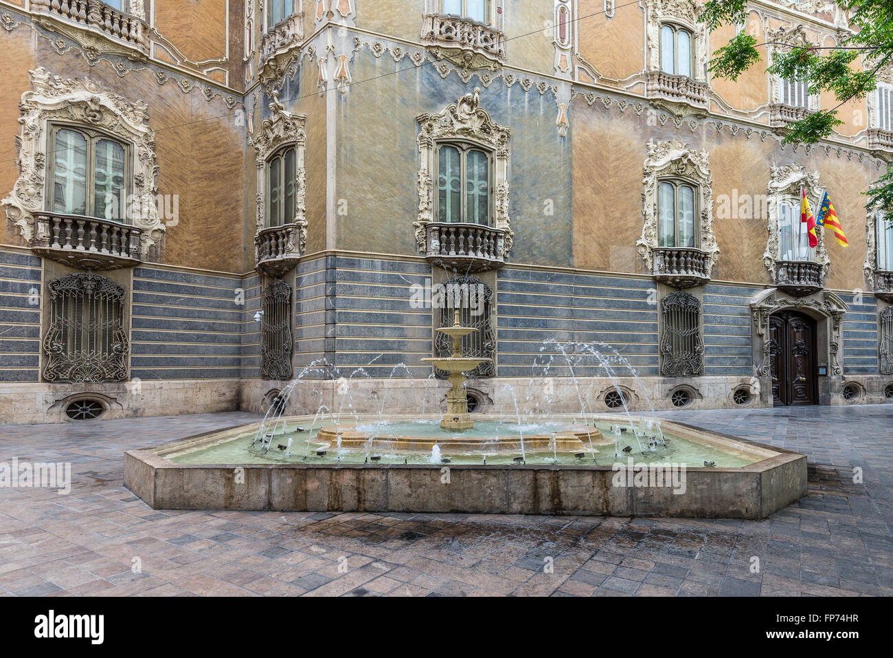 Fountain and part of the Ornate Alabaster Stone facade of the historic Palace of Marques de Dos Aguas. Stock Photo