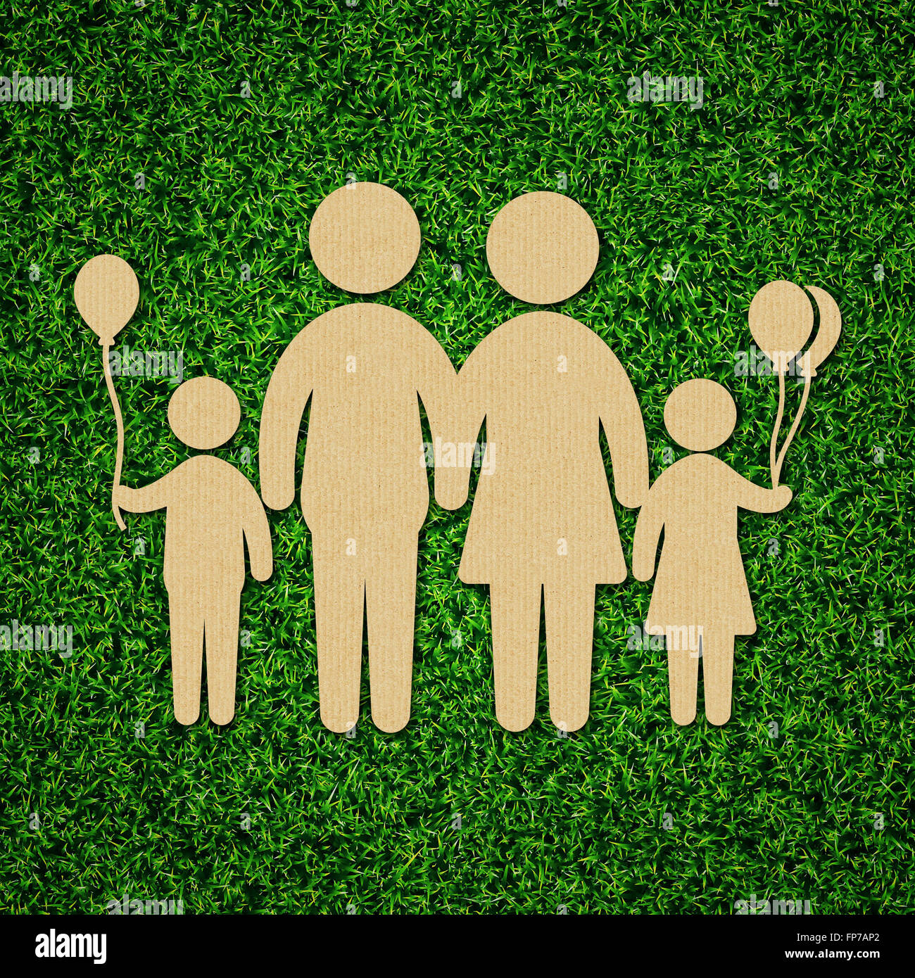 Family concept illustration with cardboard cut out on grass Stock Photo Alamy