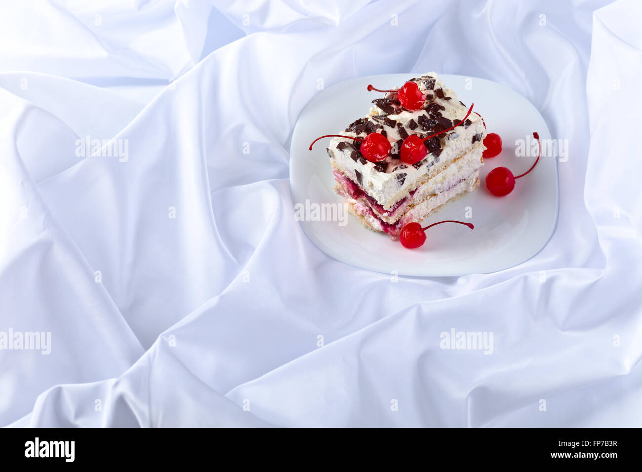 Homemade cake with cherries and chocolate on white plate Stock Photo ...