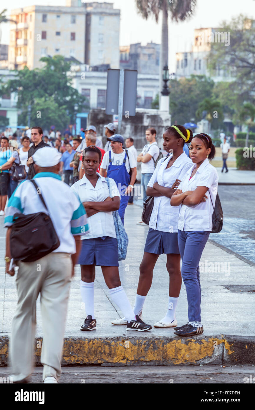 HAVANA, CUBA - APRIL 2, 2012: Group of uniformed cuban students waiting bus at morning Stock Photo