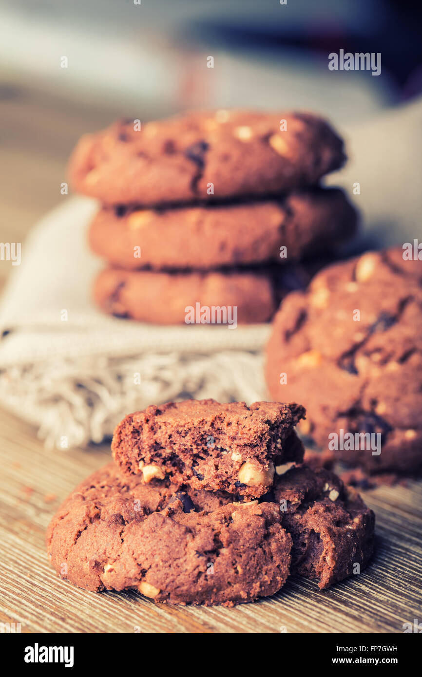 Chocolate biscuit cookies. Chocolate cookies on white linen napkin on wooden table. Stock Photo