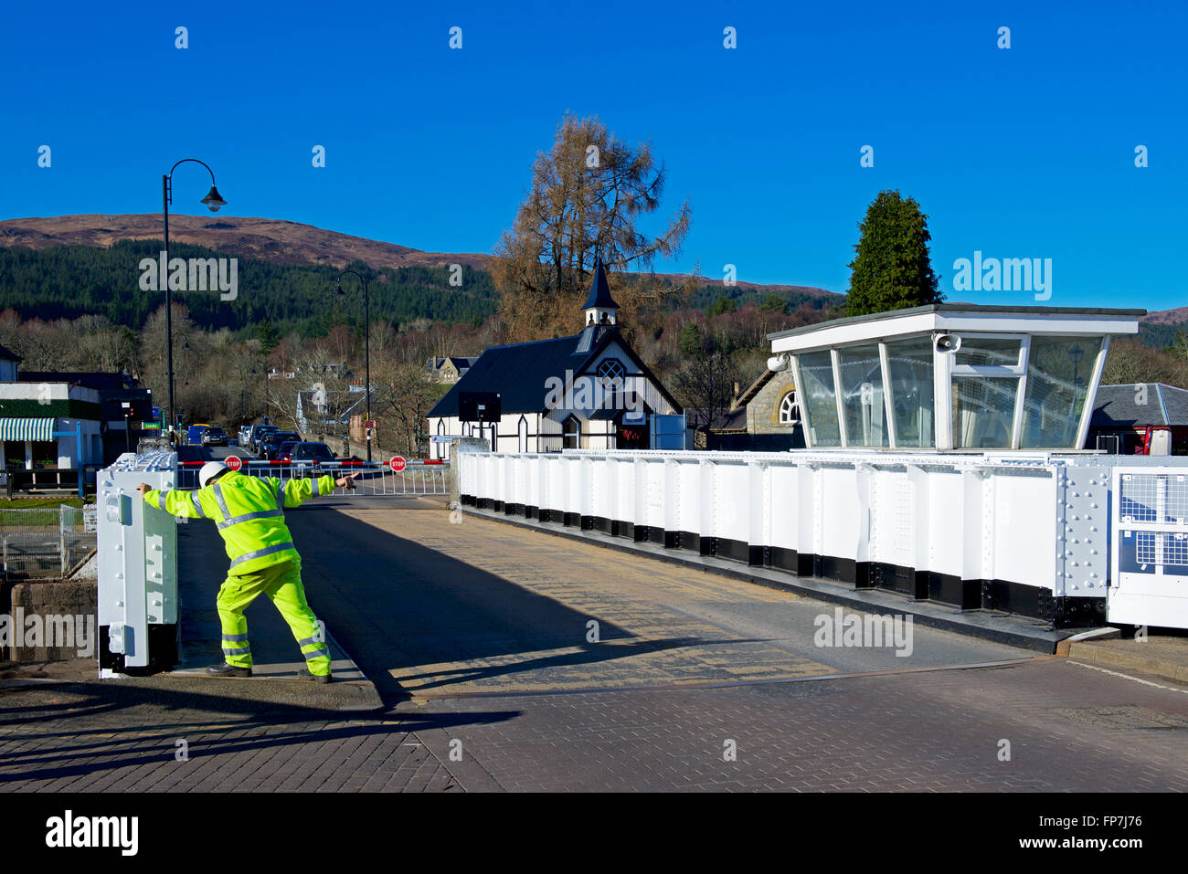 Man trying to open the swing brige over the Caledonian Canal at Fort Augustus, the Highlands, Scotland UK Stock Photo