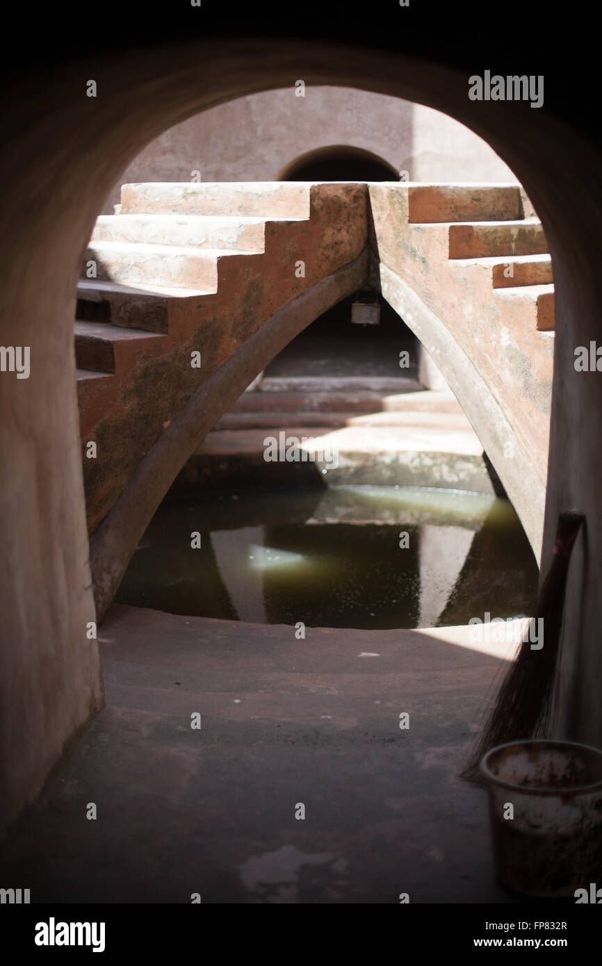 Steps Over Pond Seen Through Archway Stock Photo