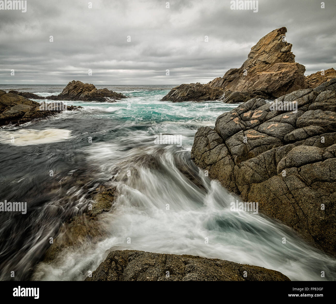Waves wash through rocky coastline along California's Big Sur coast Stock Photo