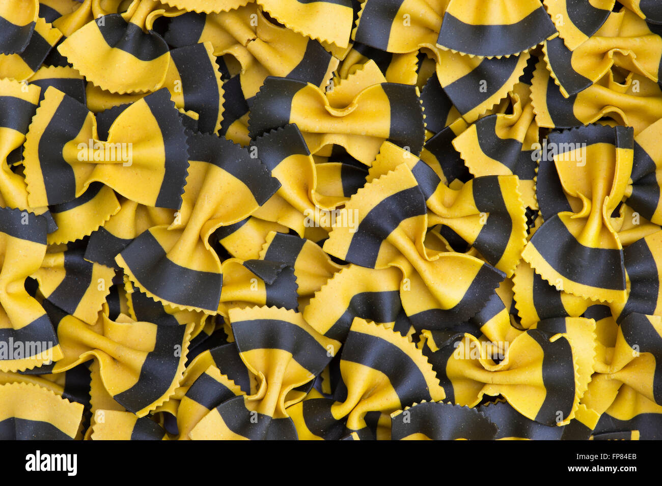 Butterfly Fantasia Yellow & Black. Farfalle pasta. Flavored coloured Pasta. Specialty pasta Stock Photo