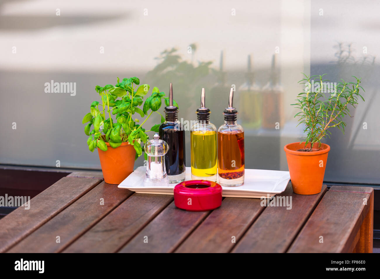 Balsamic vinegar and oil bottles and condiments on the table in an