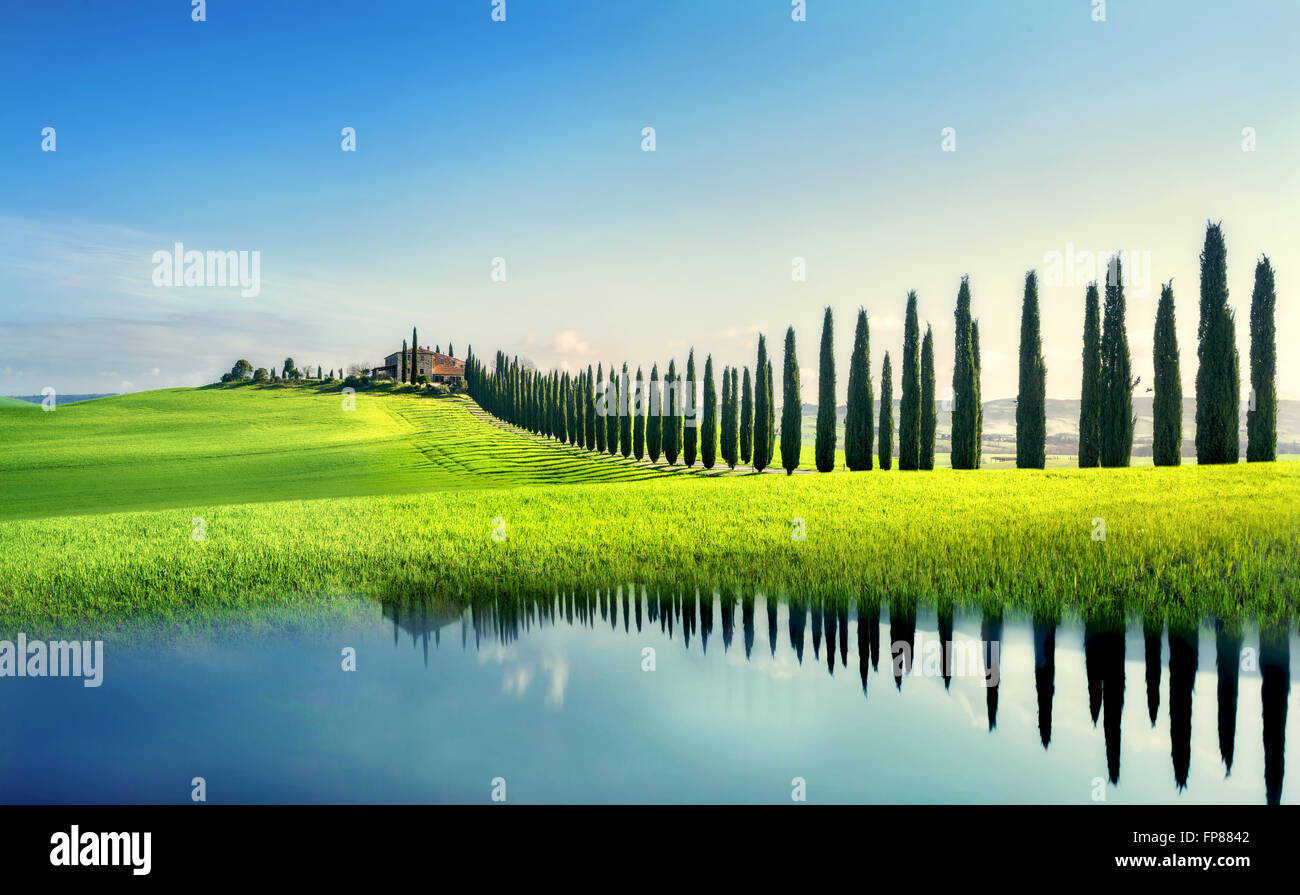 Tuscany landscape with cypress trees reflection in mirrored surface. Val d'Orcia province,Tuscany, Italy Stock Photo