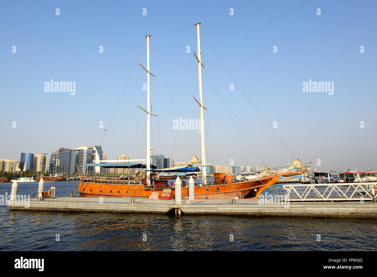 The wooden yacht is in a port of Dubai Creek, United Arab Emirates Stock Photo