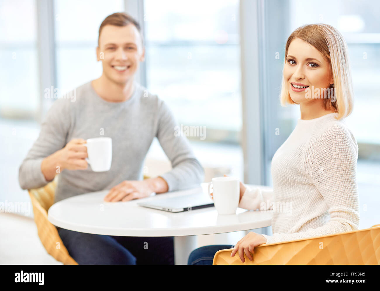 Glad students drinking coffee Stock Photo Alamy