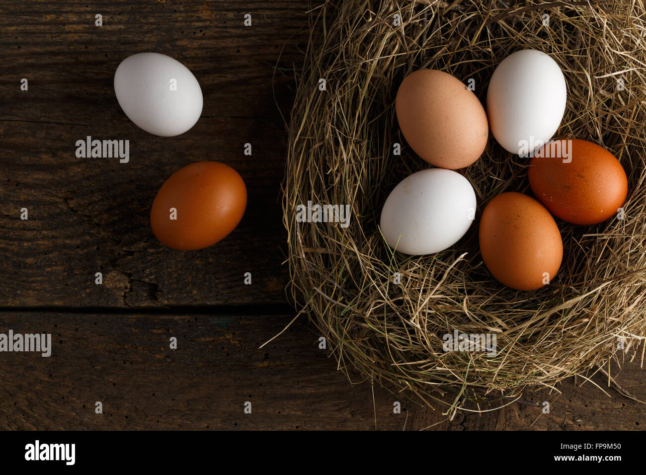 Fresh chicken eggs in a nest on a wooden rustic background Stock Photo ...