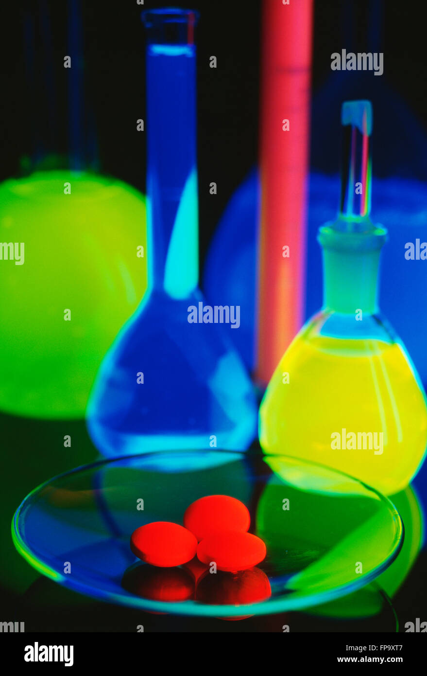 Chemistry Lab Ware containing Florescent Chemicals Stock Photo