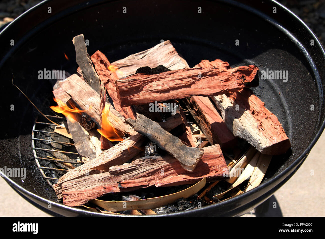 Burning kindling in portable bbq barbecue Stock Photo Alamy