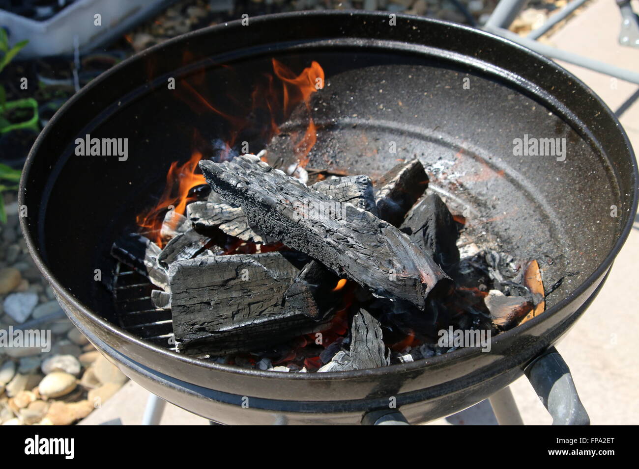 Burning kindling in portable barbecue Stock Photo Alamy