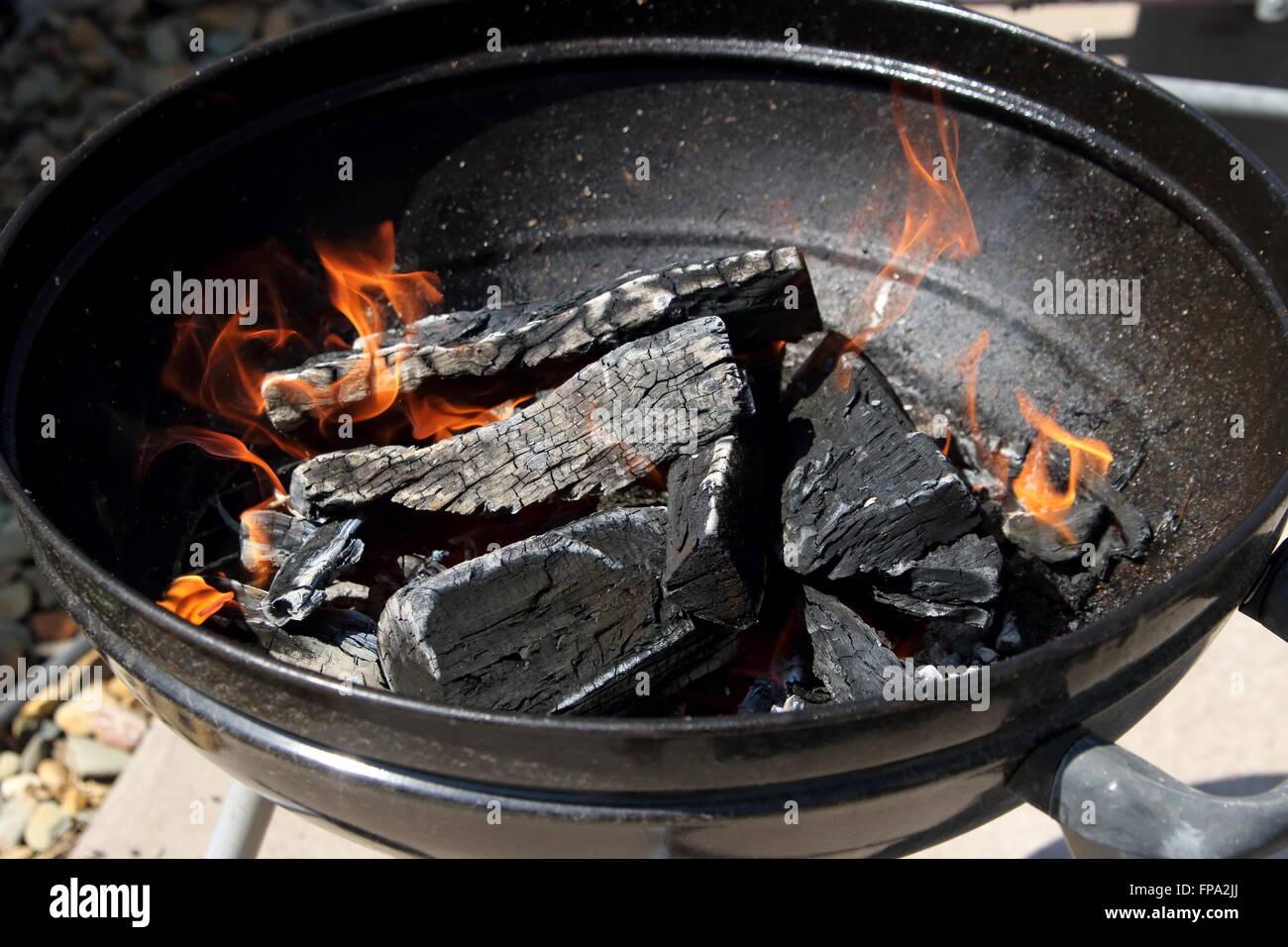 Burning kindling in portable bbq barbecue Stock Photo Alamy