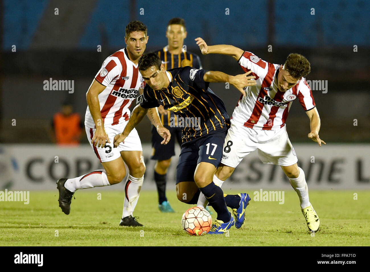 Montevideo, Uruguay. 17th Mar, 2106. Fernando Gorriaran (R) of Uruguay's River Plate vies for the ball with German Herrera (L) of Argentina's Rosario Central, during the Group 2 match of the Libertadores Cup, held at Centenario Stadium in Montevideo, capital of Uruguay, on March 17, 2106. Rosario Central won by 3-1. © Nicolas Celaya/Xinhua/Alamy Live News Stock Photo