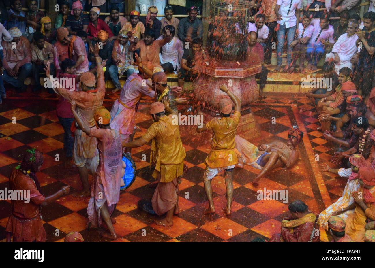 Mathura, India. 17th Mar, 2016. Devotees of Nandgaon dance during the Lathmar holi festival at Radhe Rani Temple. In the lathmar holi, the women of Barsana (hometown of Radha) beat man of Nandgaon(hometown of Lord Krishna) with wooden sticks in response to their teasing. © Prabhat Kumar Verma/Pacific Press/Alamy Live News Stock Photo