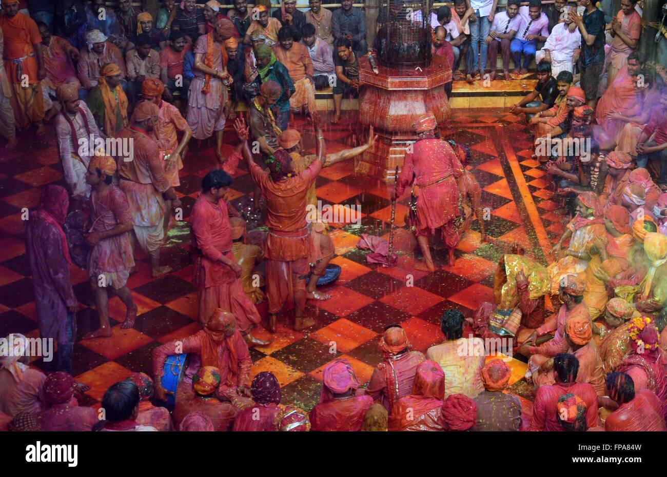 Mathura, India. 17th Mar, 2016. Devotees of Nandgaon dance during the Lathmar holi festival at Radhe Rani Temple. In the lathmar holi, the women of Barsana (hometown of Radha) beat man of Nandgaon(hometown of Lord Krishna) with wooden sticks in response to their teasing. © Prabhat Kumar Verma/Pacific Press/Alamy Live News Stock Photo