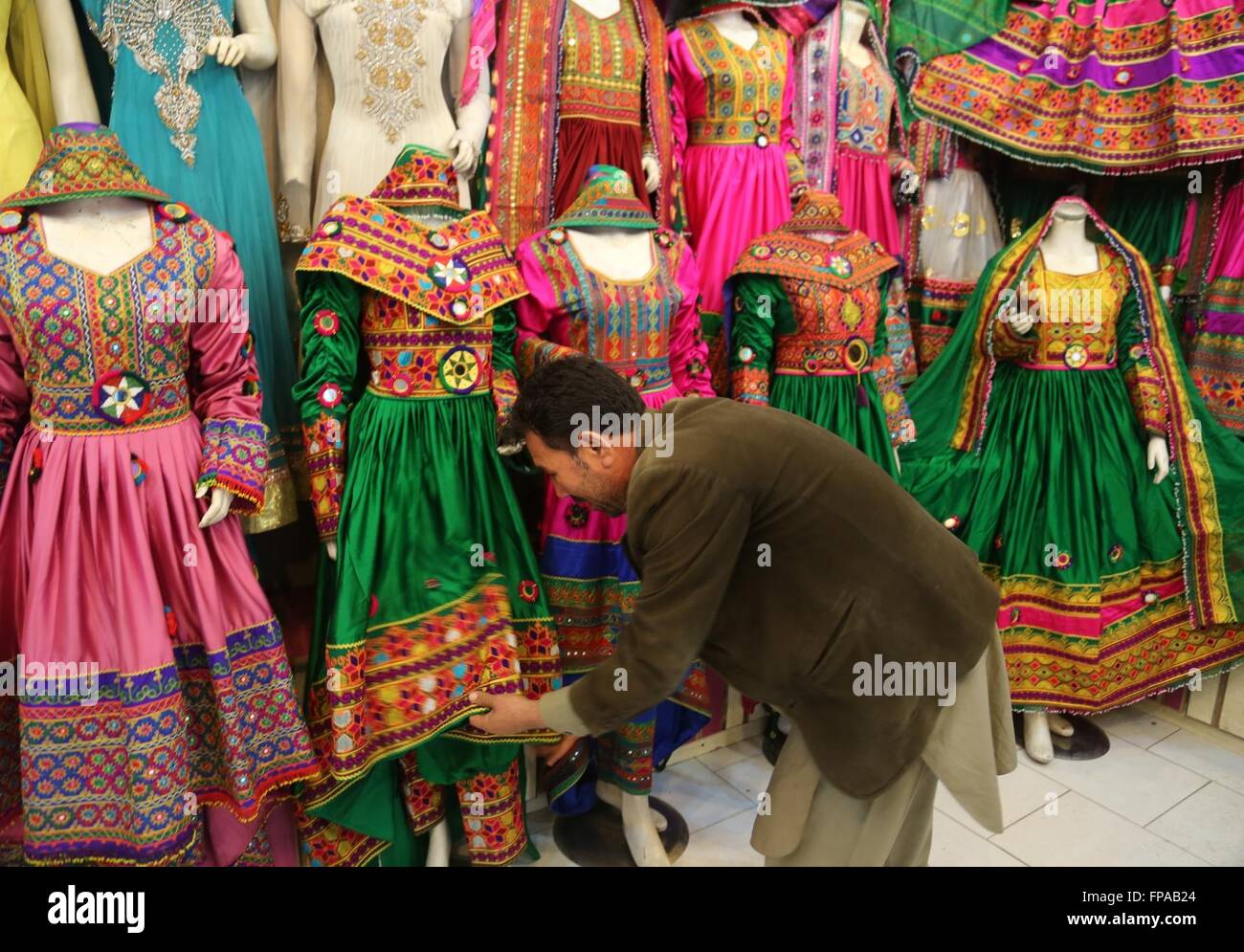 Kabul, Afghanistan. 18th Mar, 2016. An Afghan vendor prepares clothes
