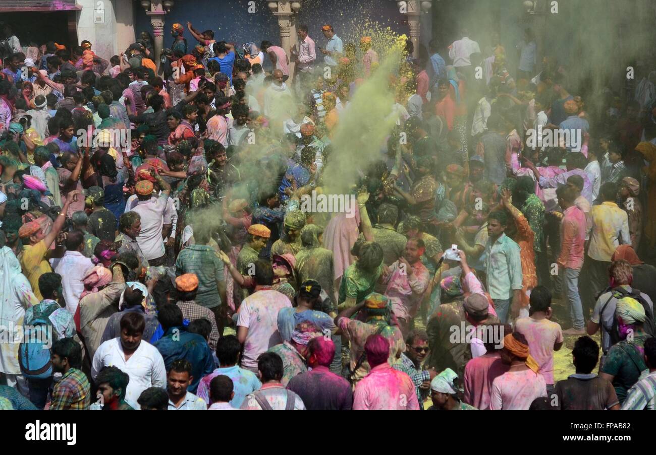 Mathura, Uttar Pradesh, India. 18th Mar, 2016. Mathura: Devotee throwing color powder and dancing as they take part in celebration of Lathmar holi festival Nandgaon in Mathura on 18-03-2016. Lath mar Holi is a local celebration of the Hindu festival of Holi. It takes place days before the actual Holi in the neighbouring towns of Barsana and Nandgaon near Mathura in the state of Uttar Pradesh, where thousands of Hindus and tourists congregate, each year, The name means ''that Holi in which [people] hit with sticks' Credit:  Prabhat Kumar Verma/ZUMA Wire/Alamy Live News Stock Photo