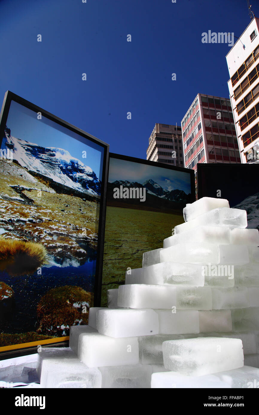 La Paz, Bolivia, 18th March 2016. Blocks of ice slowly melt in front of photos of Bolivia's mountains at an event organised by the La Paz City Government. The glaciers in Bolivia and the central Andes are some of the fastest receding on the planet, and their disappearance is causing environmental changes and water shortages and affecting agricultural cycles in many parts of the region. Credit:  James Brunker / Alamy Live News Stock Photo