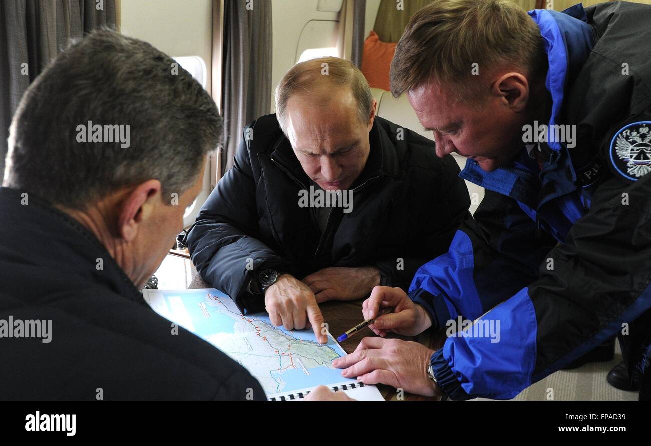 Crimea, Russia. 18th Mar, 2016. Russian President Vladimir Putin is briefed by Deputy Prime Minister Dmitry Kozak, left, and Roman Starovoit, head of the Federal Highway Agency during a fly over to view the construction on the bridge spanning the Kerch Strait March 18, 2016 in Crimea. The bridge will link mainland Russia to Crimea annexed by Putin two-years ago today. Credit:  Planetpix/Alamy Live News Stock Photo