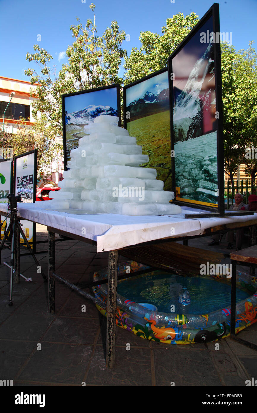 La Paz, Bolivia, 18th March 2016. Blocks of ice slowly melt in front of photos of Bolivia's mountains at an event organised by the La Paz City Government to highlight global warming for Earth Hour (which takes place tomorrow). Credit:  James Brunker / Alamy Live News Stock Photo