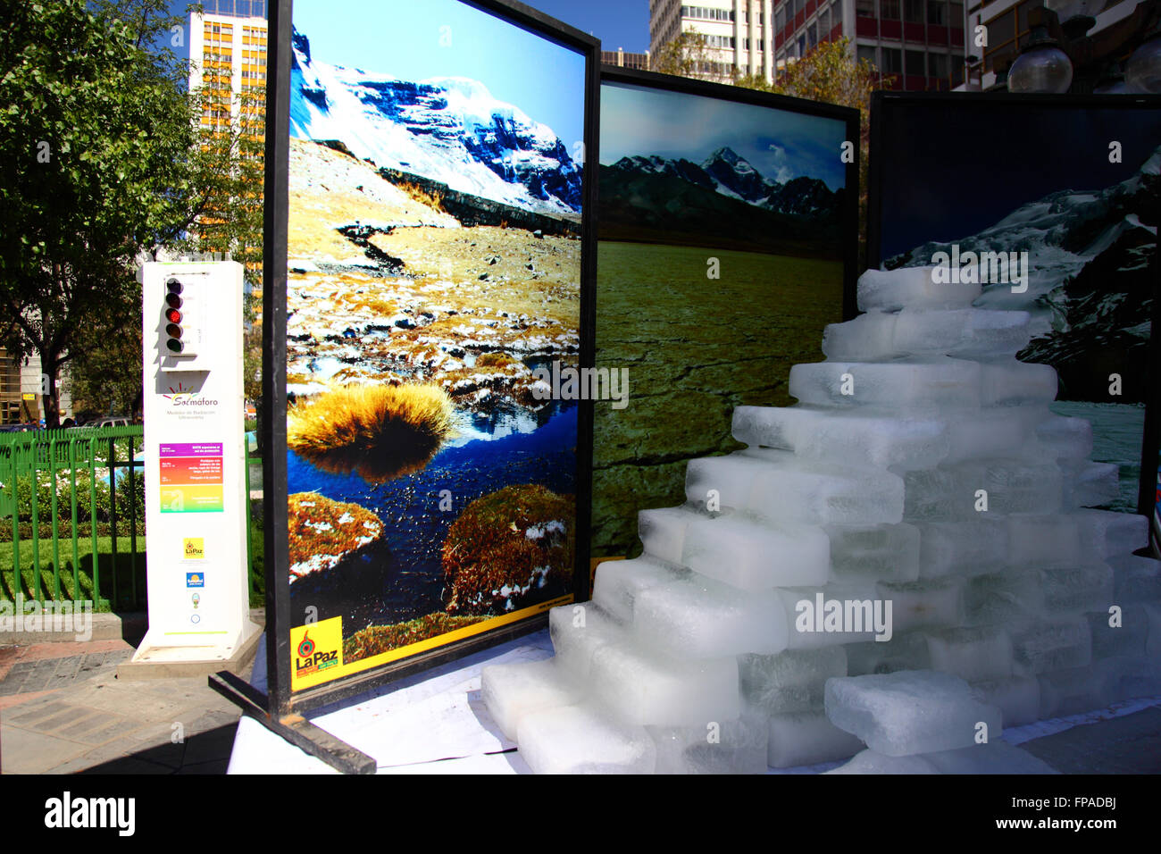 La Paz, Bolivia, 18th March 2016. Blocks of ice melt in front of photos of Bolivia's mountains at an event organised by the La Paz City Government to highlight global warming for Earth Hour (which takes place tomorrow). Next to the ice is a radiation meter showing solar UV levels. Credit:  James Brunker / Alamy Live News Stock Photo
