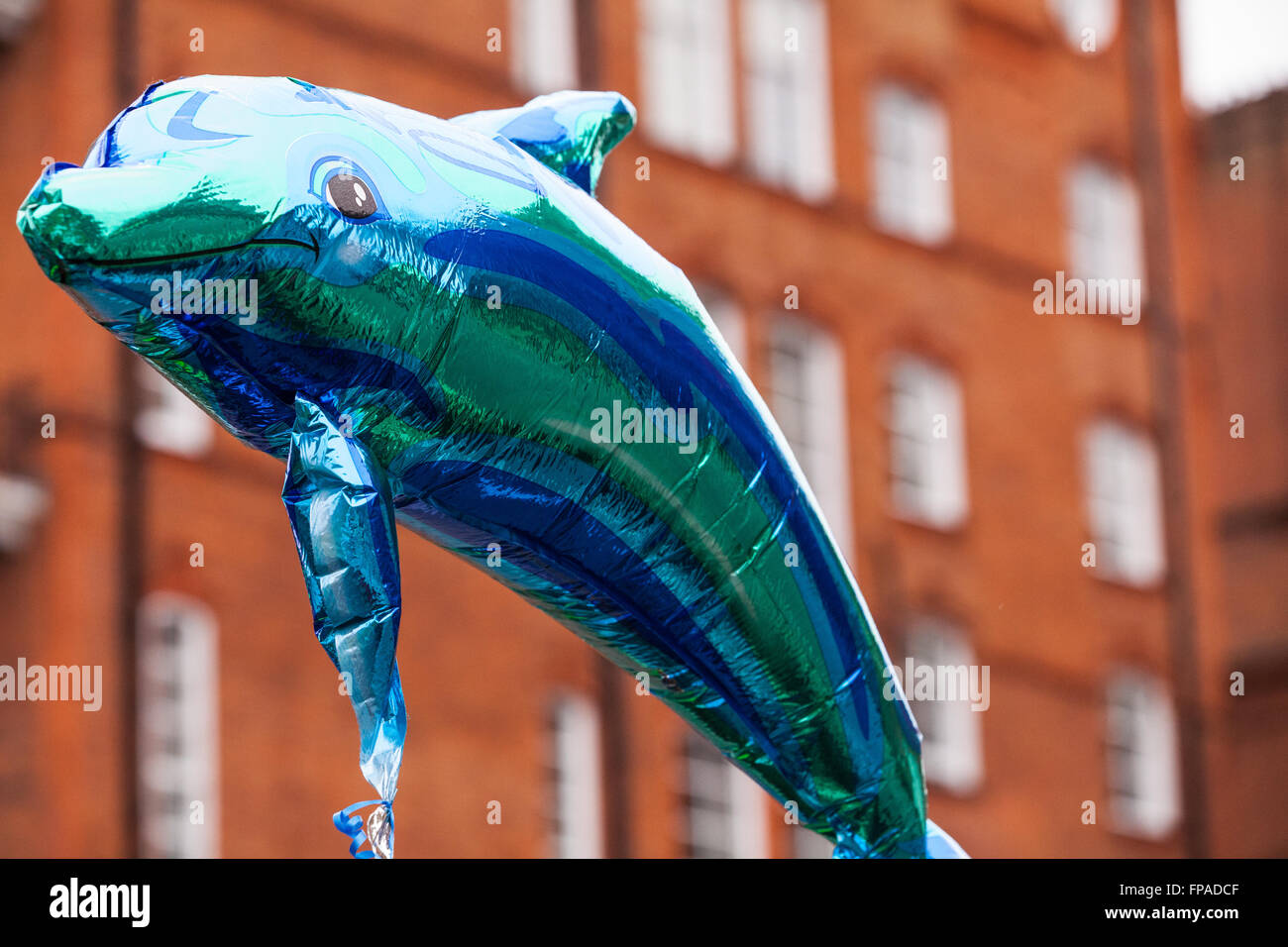 London, UK. 18th March 2016. An inflatable dolphin held by activists marching to the Japanese embassy in protest against the brutal annual slaughter of dolphins at Taiji in Japan Credit:  Mark Kerrison/Alamy Live News Stock Photo