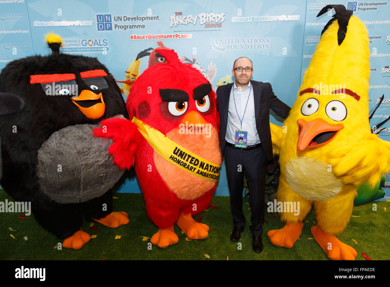 United Nations, United Nations headquarters in New York. 18th Mar, 2016. Producer of the Angry Birds movie John Cohen poses for a photo with 'Chuck', 'Red' and 'Matilda' (L to R) during the 'Angry Birds for a Happy Planet' campaign, at the United Nations headquarters in New York, March 18, 2016. UN Secretary-General Ban Ki-moon appointed Red from the Angry Birds as Honorary Ambassador for Green on the International Day of Happiness and encouraged young people to take action on climate change and make the Angry Birds happy. Credit:  Li Muzi/Xinhua/Alamy Live News Stock Photo