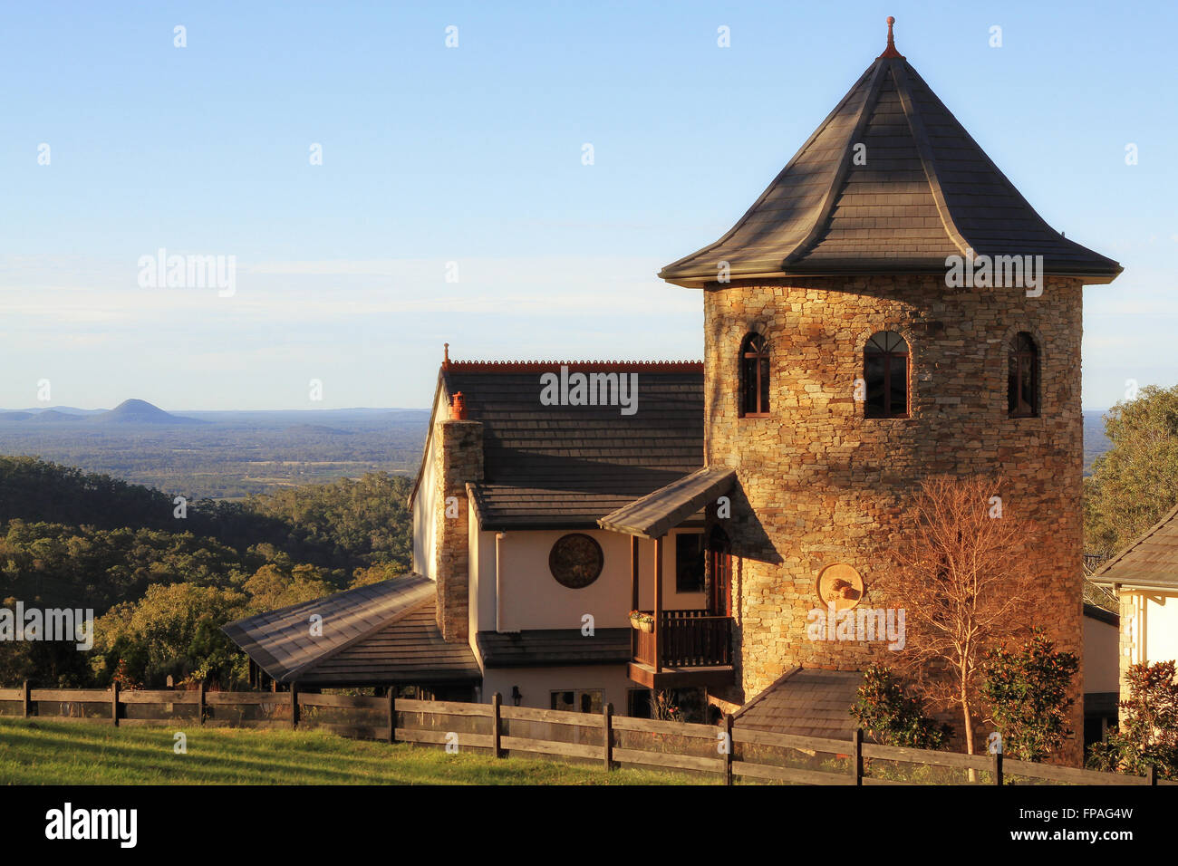 sunlit desirable residence modelled around an oast house  with Glass house mountains in distance, brisbane, queensland australia Stock Photo