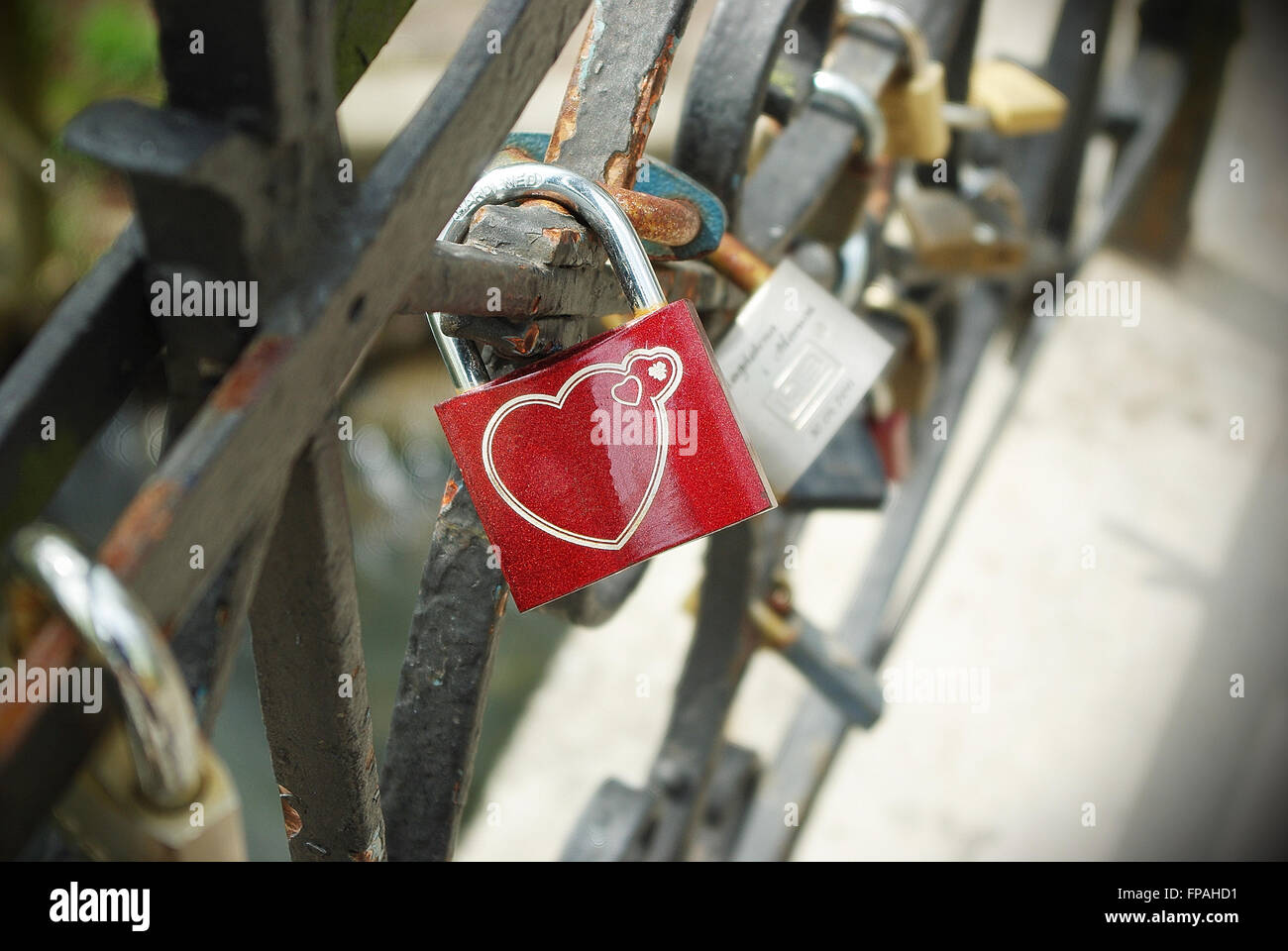 Red padlock with symbol of heart and love locked on handrail Stock ...
