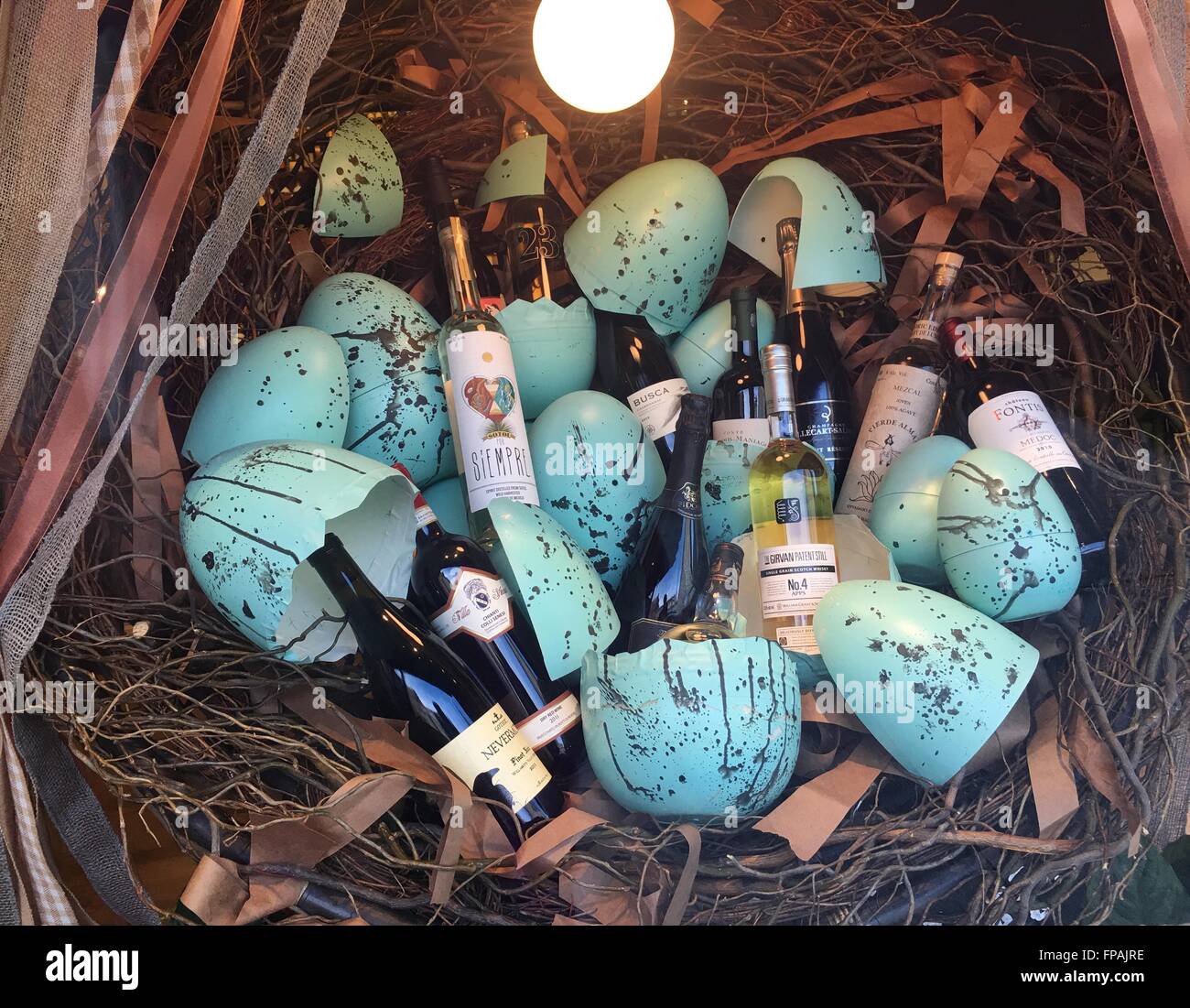 Liquor store easter display which bottles and cracked blue eggs on hay