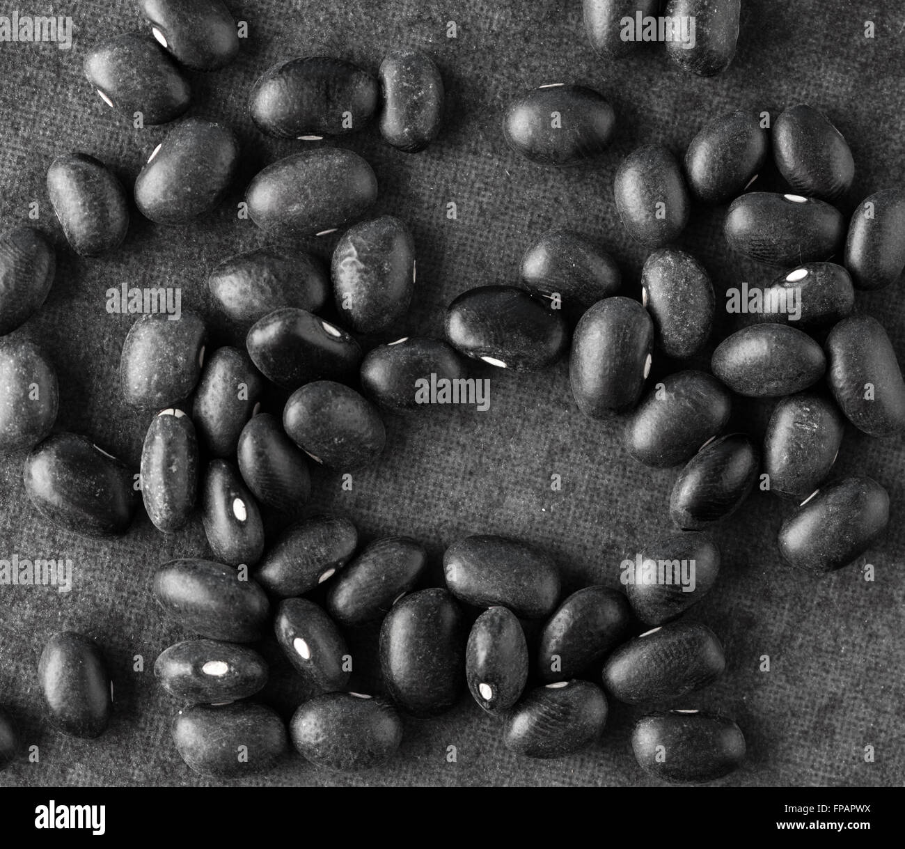 Black turtle beans on dark surface. Top view. Stock Photo