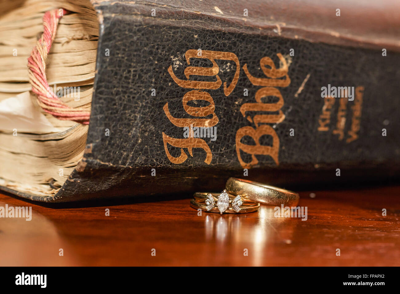 an old bible with gold wedding rings Stock Photo Alamy