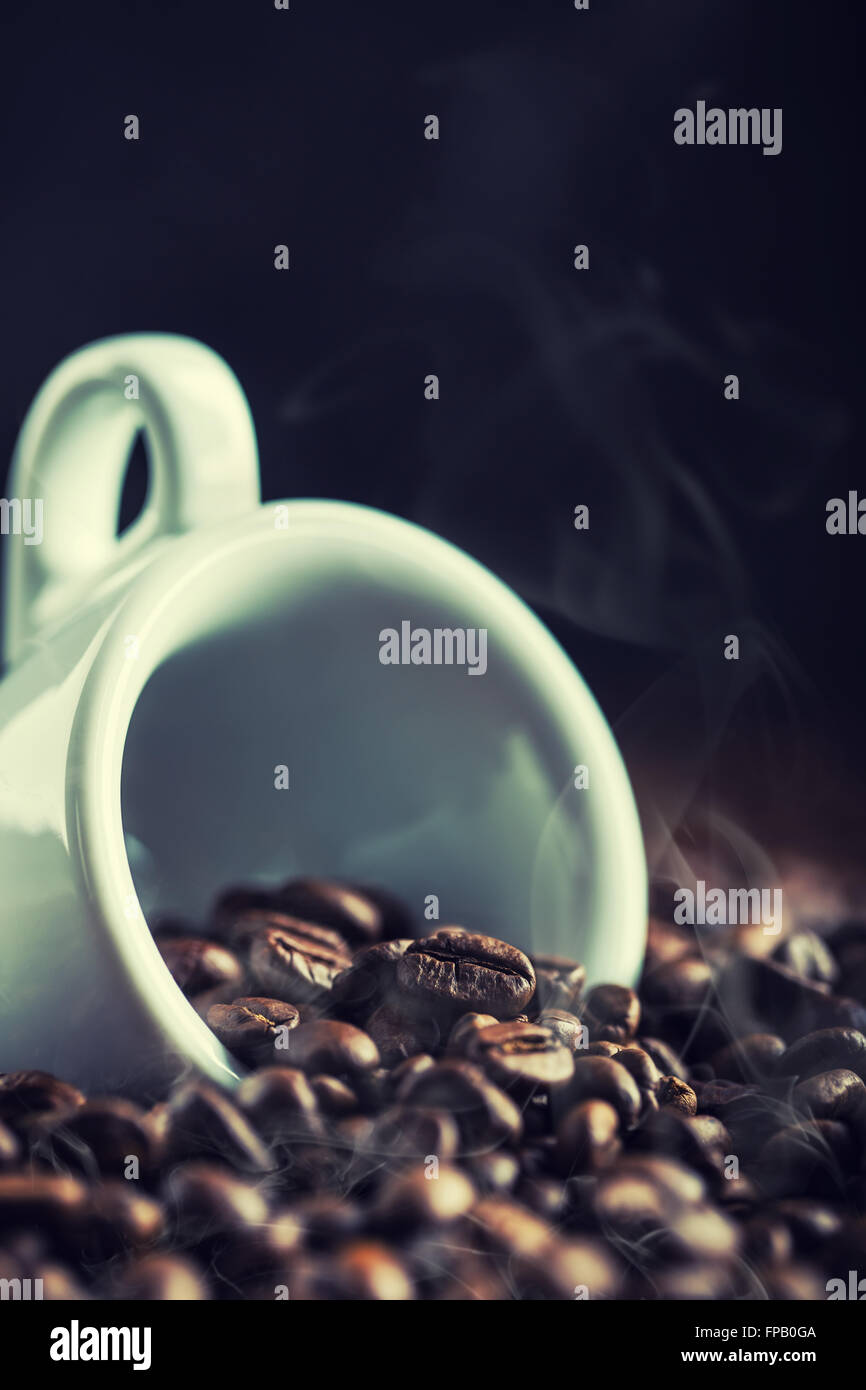 Coffee. Coffee beans. Coffee cup full of coffee beans. Spilled coffee beans. Toned image. Stock Photo