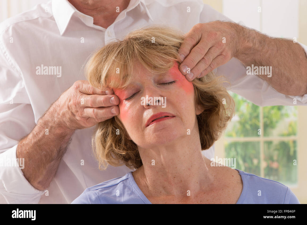 Middle Aged Woman Having Temples Massaged Stock Photo